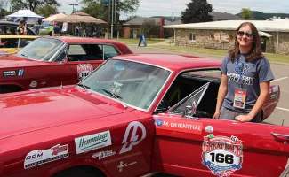 Olivia Gadjo outside of her team’s 1966 Ford Mustang.