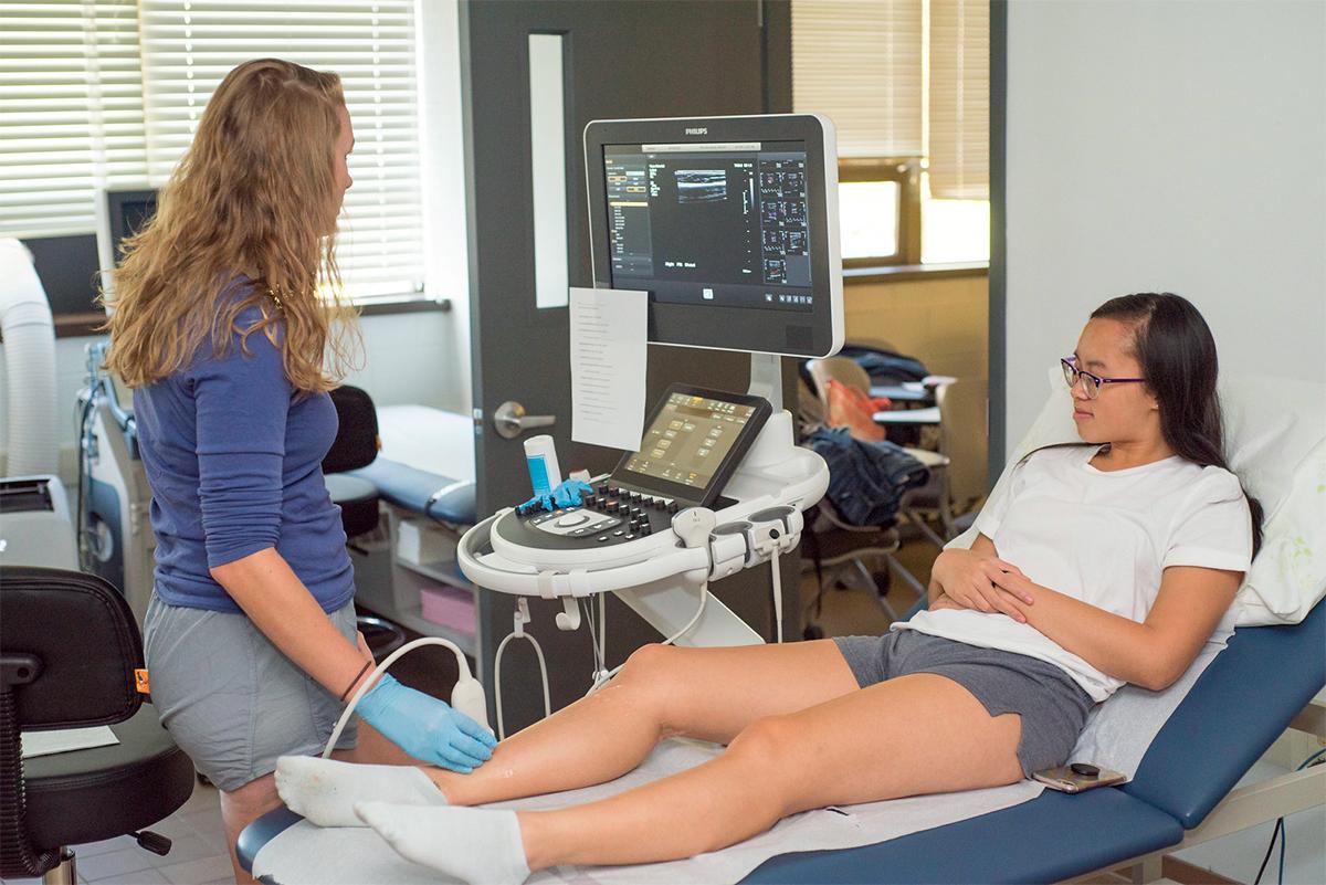 A student nurse examining a patient