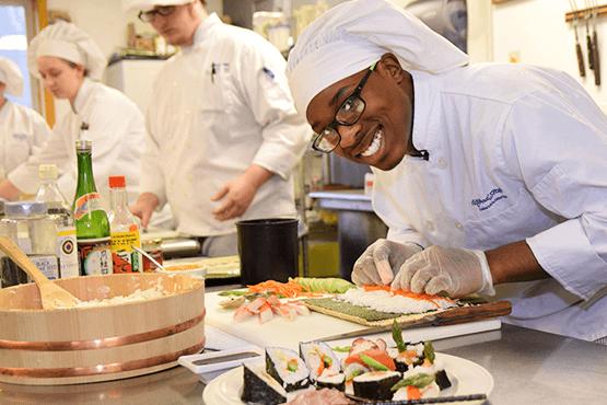 Charles Richards in a kitchen preparing a sushi dish