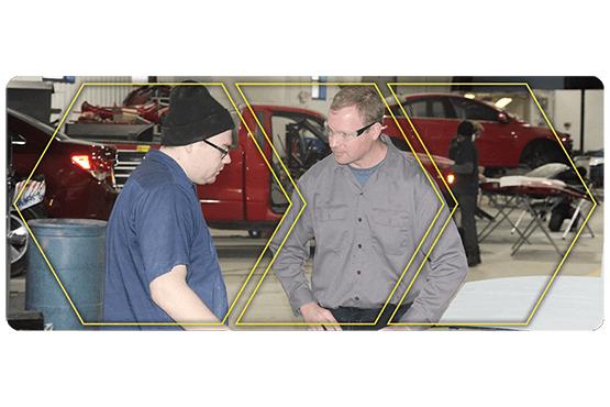 Christopher Tremper with a student in the automotive lab