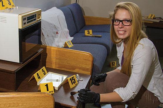 Christy Dodd kneeling next to a chair