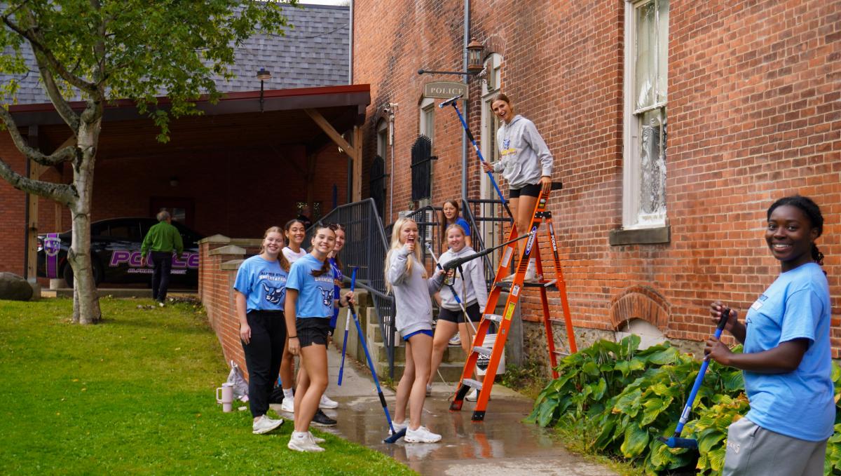   Students cleaning a building for Community Service Day

