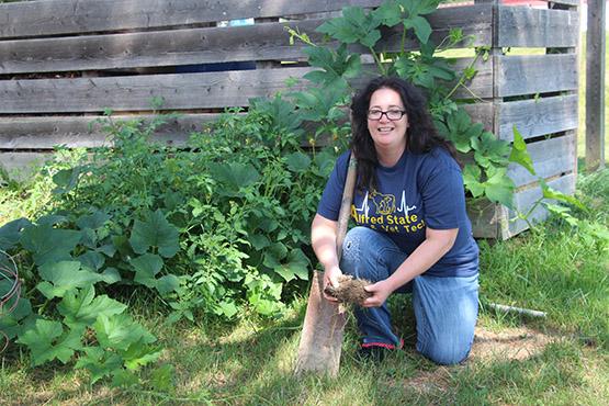 Jessica Hutchison works on the soils in the college garden