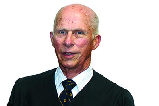 James Koller wearing a black coat and tie