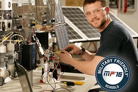 Jordon Williams at the solar lab, Military Friendly Schools 2016 logo in corner