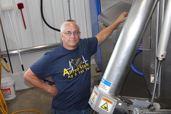 Phil Schroeder works with the automated milking system