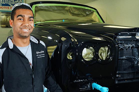 Ryan in front of a car