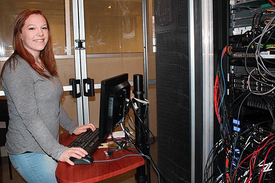 Shelby Detro standing next to a computer