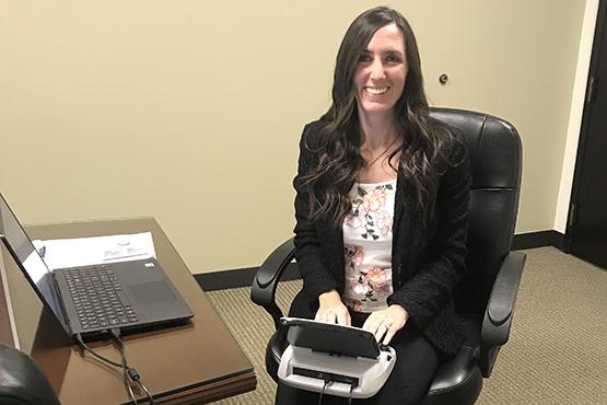 A student posing while working as a court reporter