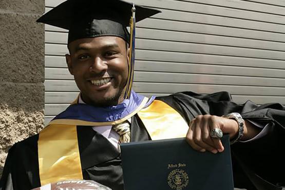 Thomas Daniels holding diploma