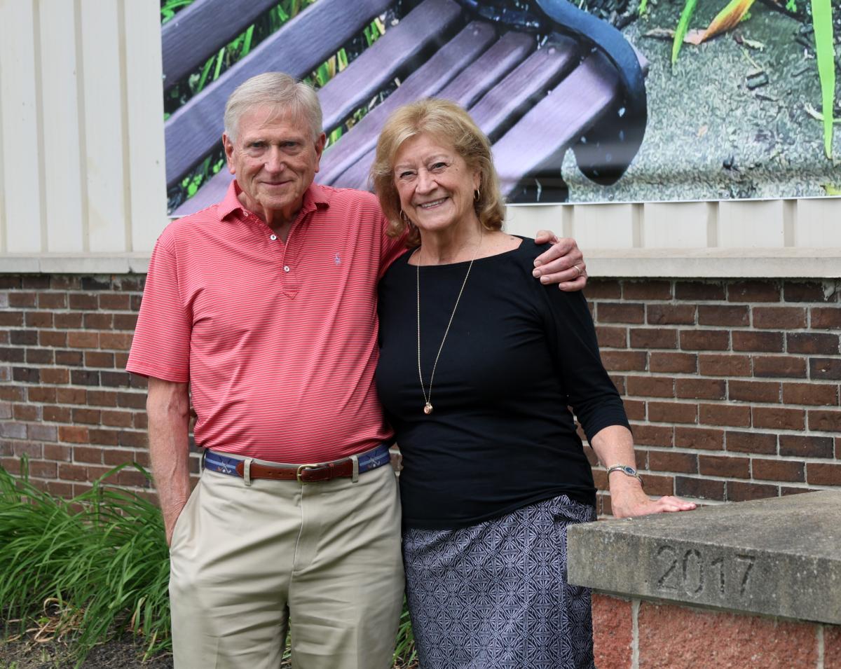 Tom and Dottie Kelsey stand outside the Wellsville campus