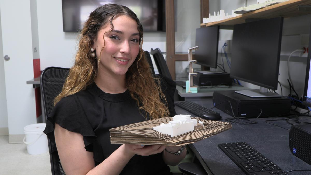 student holds an architectural model
