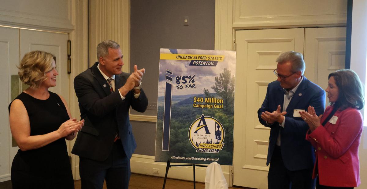 Dr. Mauro celebrates the unveiling of the comprehensive campaign progress.