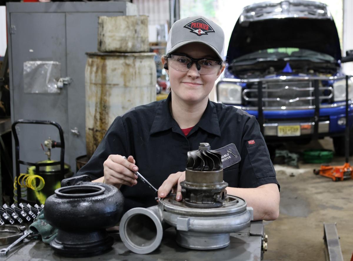 student works on an autopart