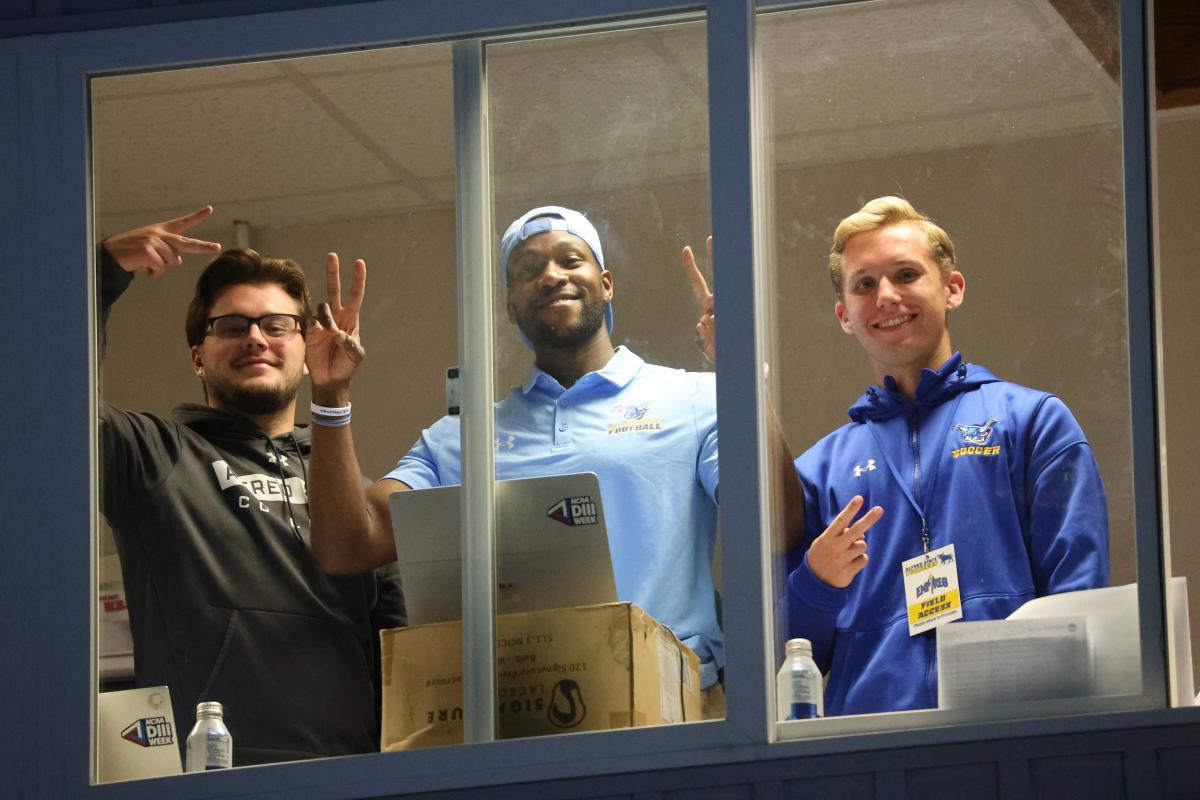 Will Rollison along with a pair of students in the pressbox