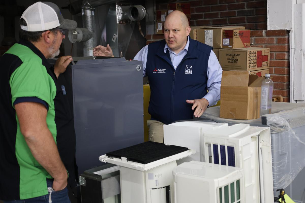 An instructor talks about equipment with a donor.
