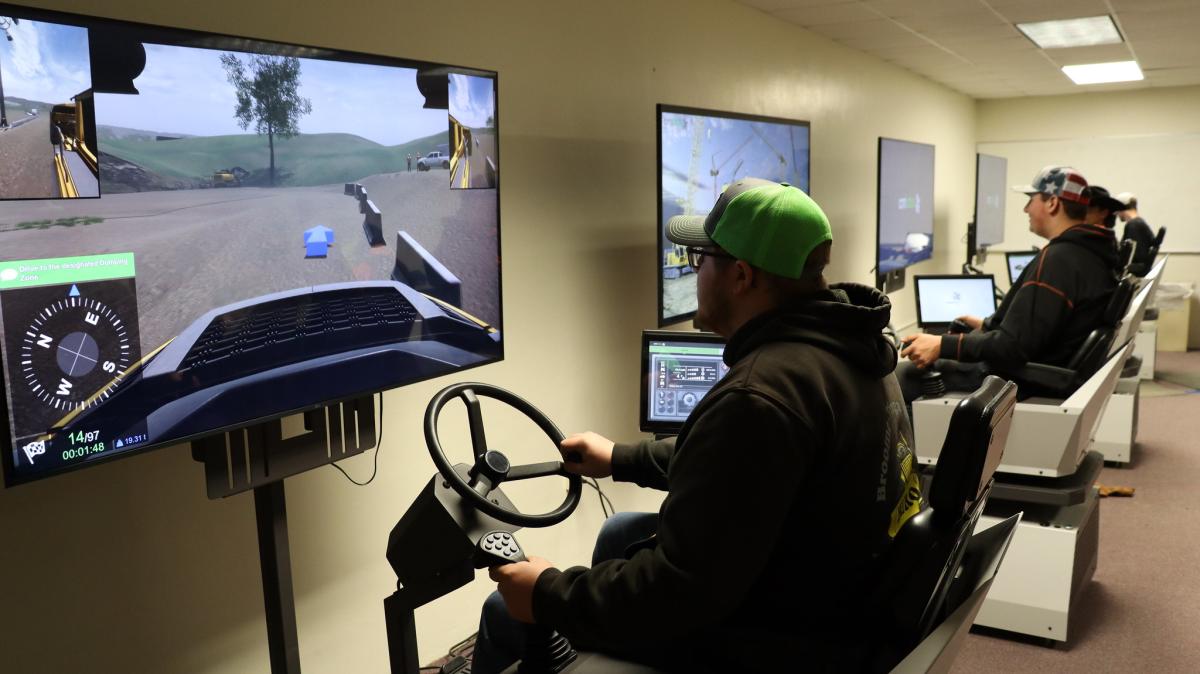 students use heavy equipment simulators