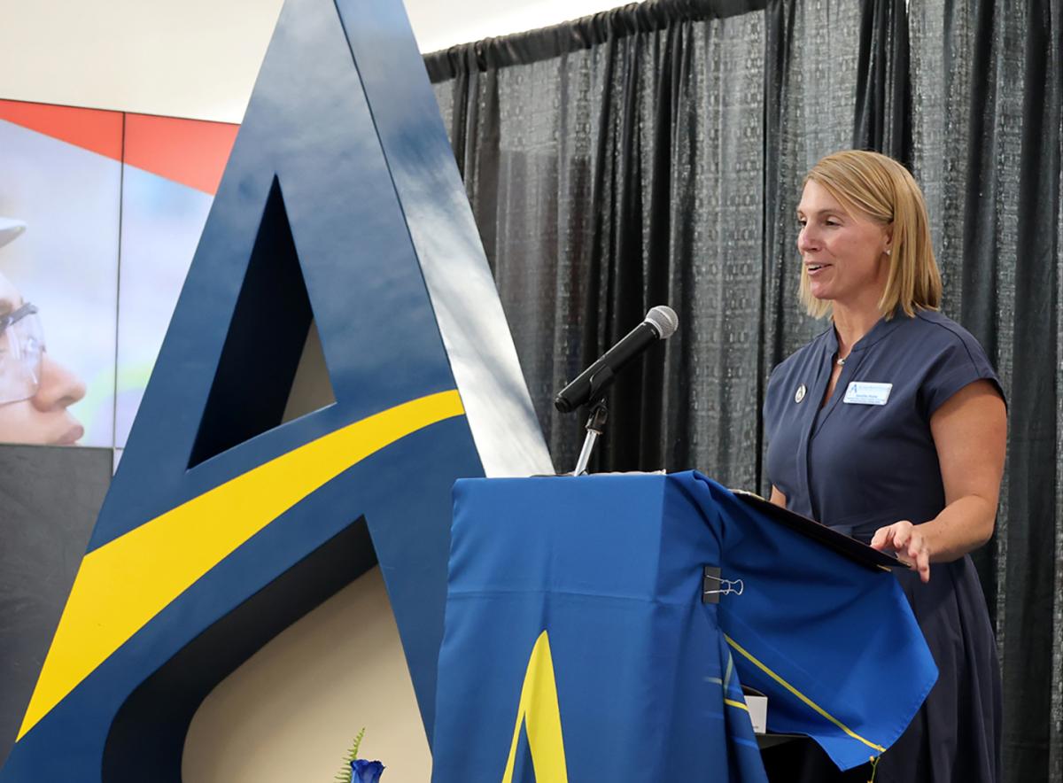 Jennifer Noble stands at the podium