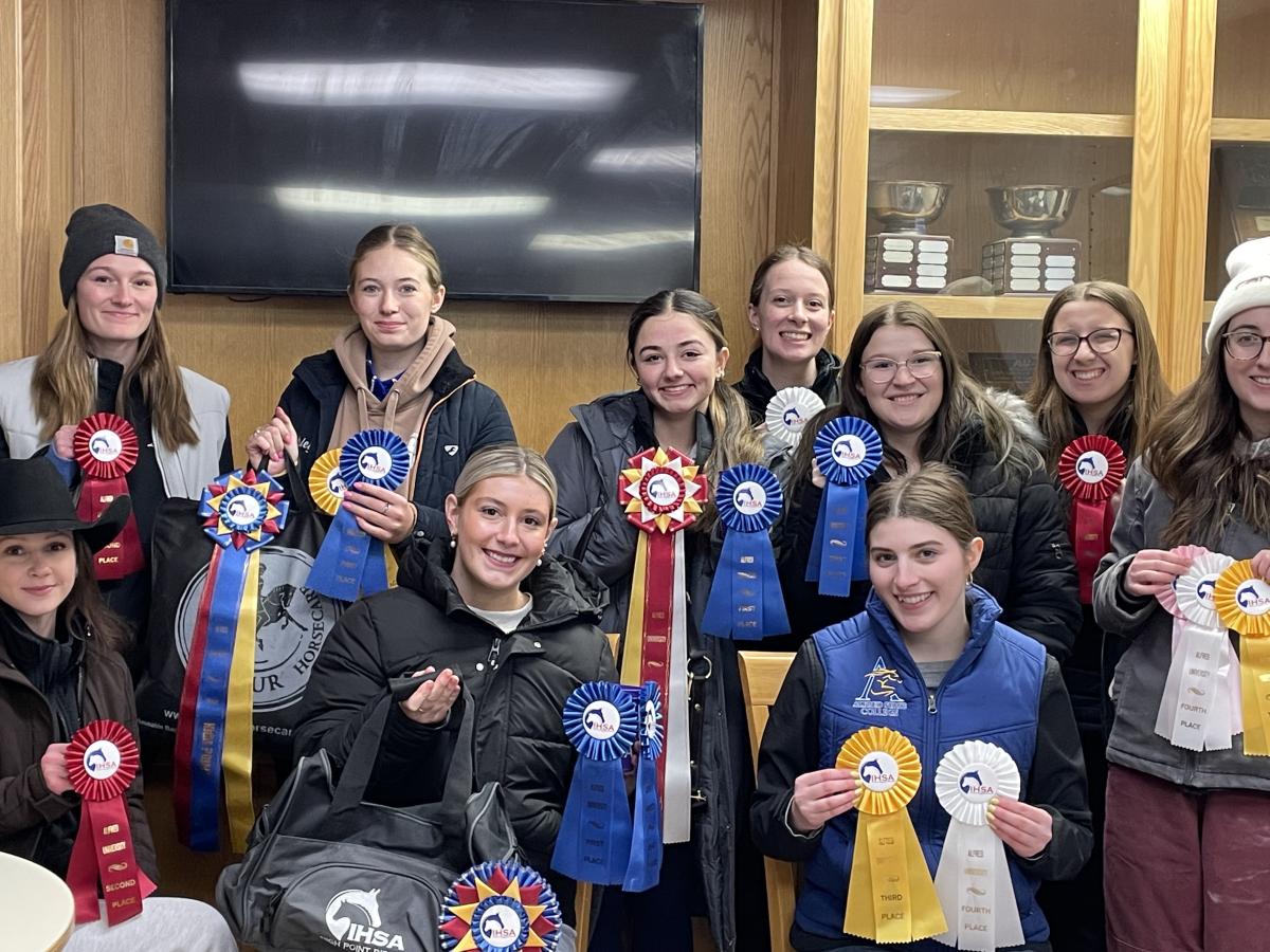 Athletes pose with awards