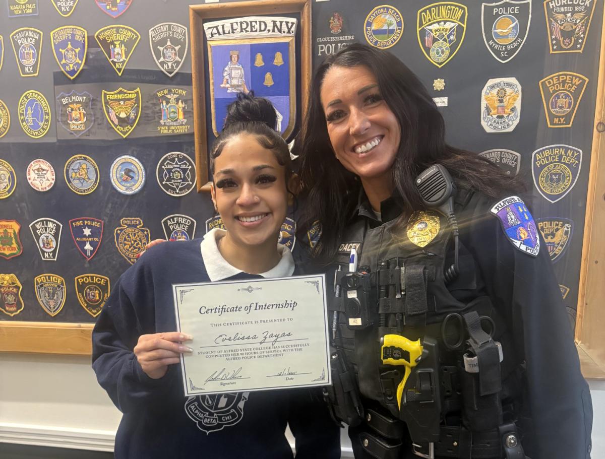 Student poses with Officer after completing her internship with the Police Department