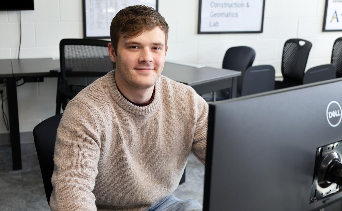 student sits in front of a computer!