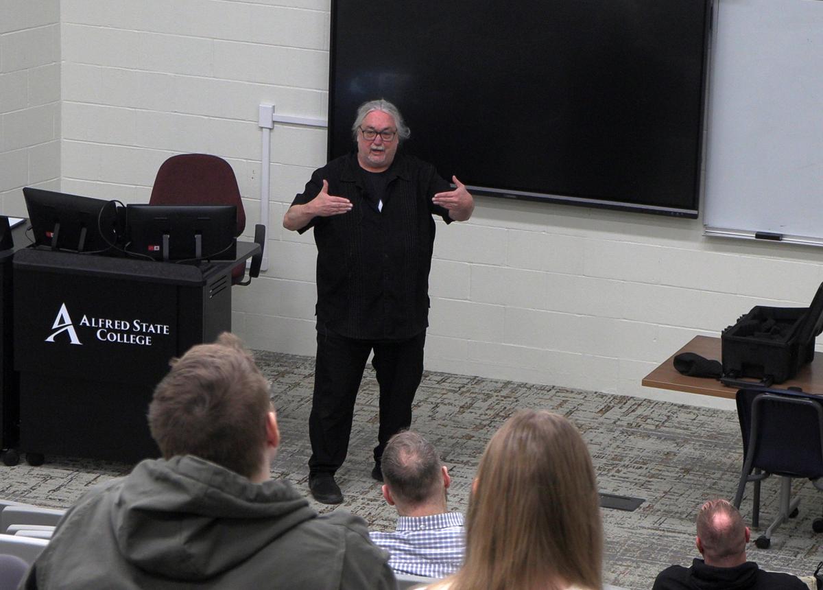 Dean Lyons speaks with students in a lecture hall