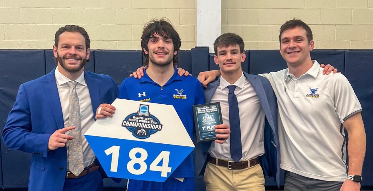 Sean Malenfant stands with his coaches.