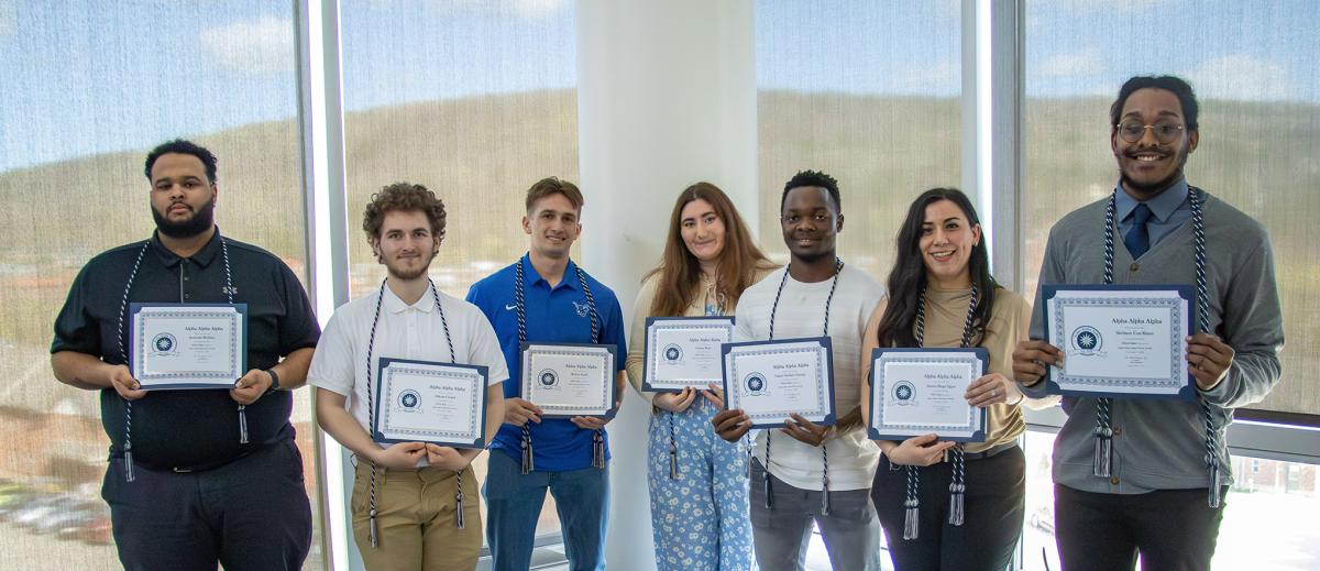 the inaugural class of Alpha Alpha Alpha shows off their awards