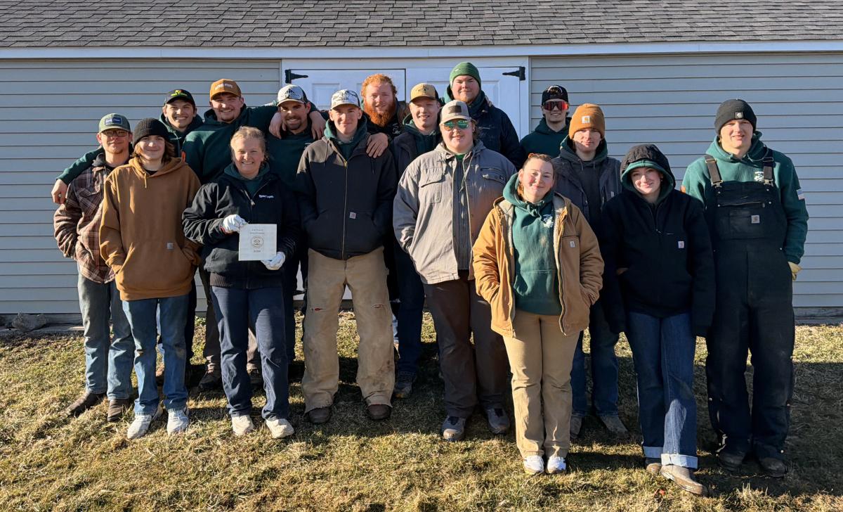 Logging sports team poses after their home meet