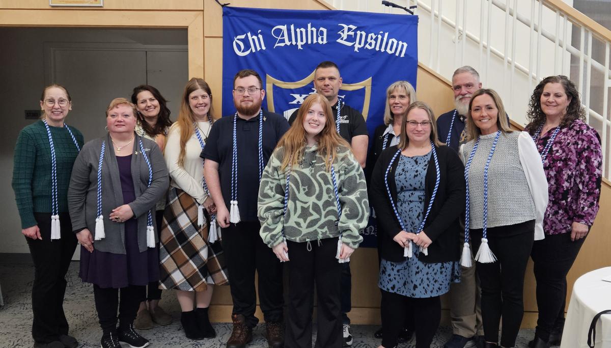 The 2026 Class of Chi Alpha Epsilon poses with faculty and staff.