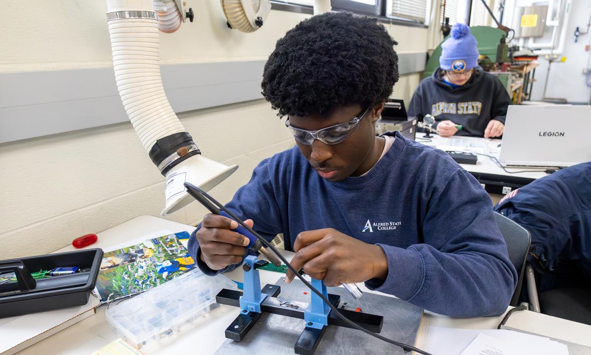 student works on an engineering project in a lab