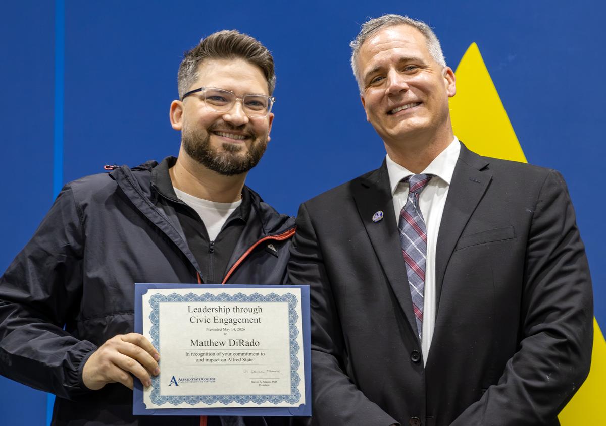 Matt DiRado stands with President Mauro after receiving the Leadership through Civic Engagement Award.