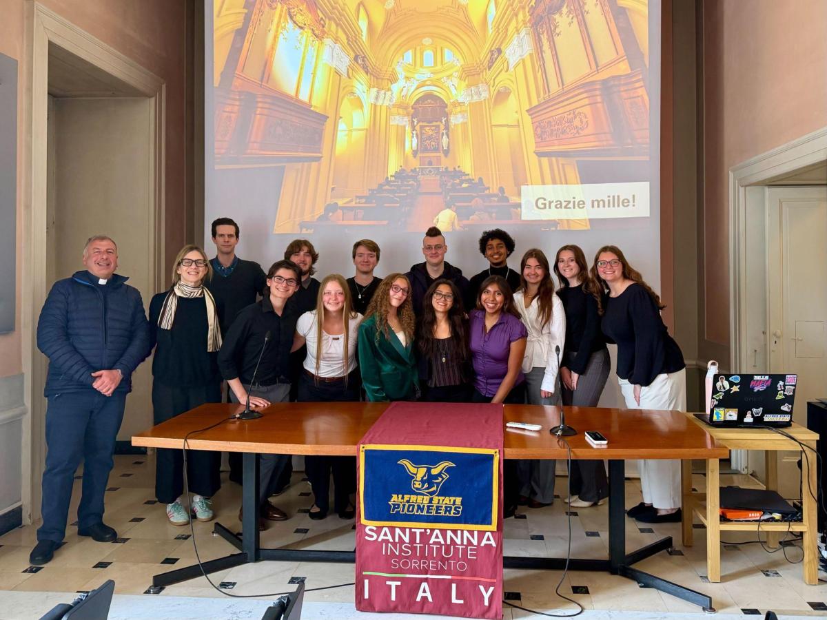 students pose after a presentation