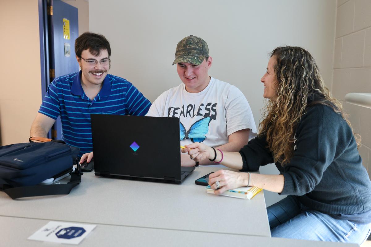 student works with a pair of student success coaches
