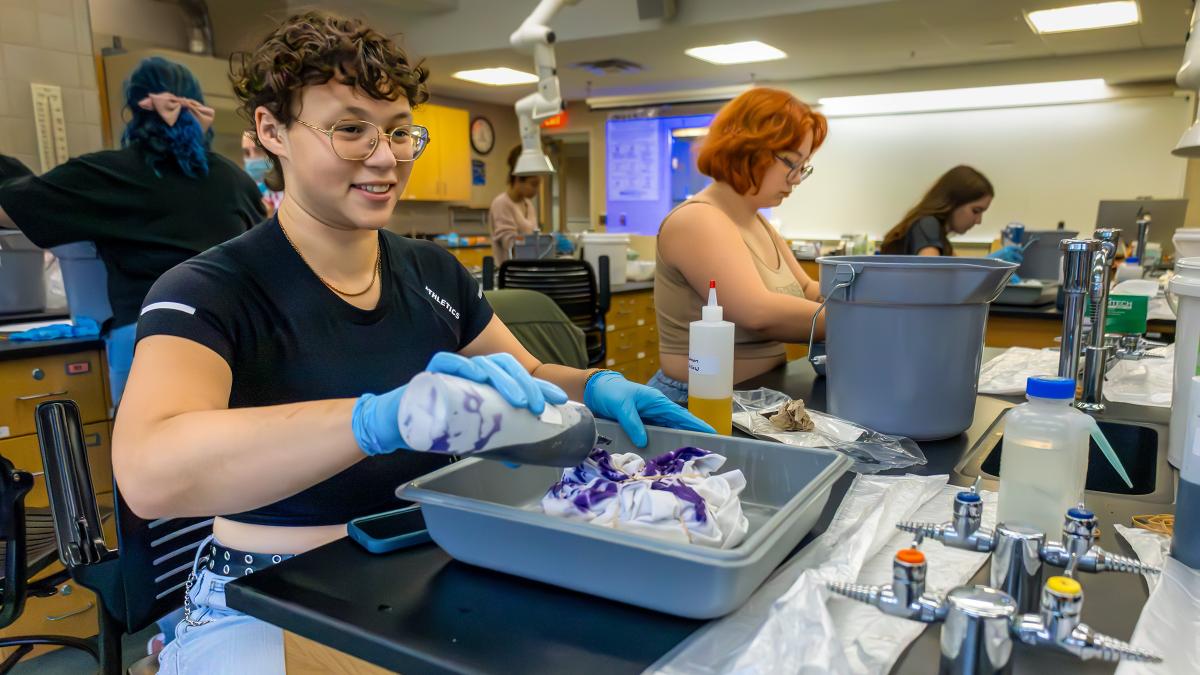 Students participate in a laboratory activity, using dye and materials at workstations while completing a hands on learning exercise in a science classroom.