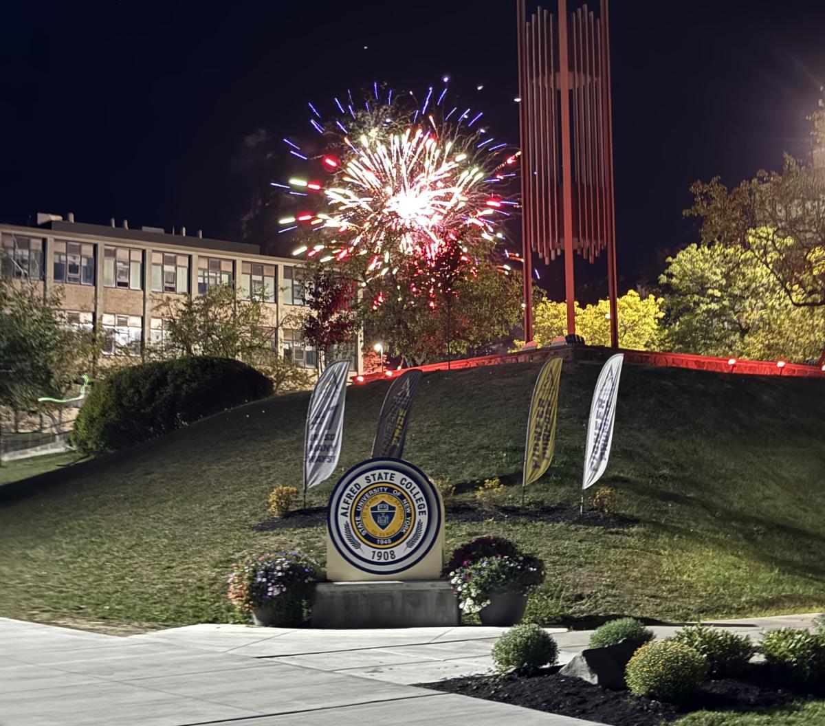 Fireworks explode behind the Belltower and Seal 