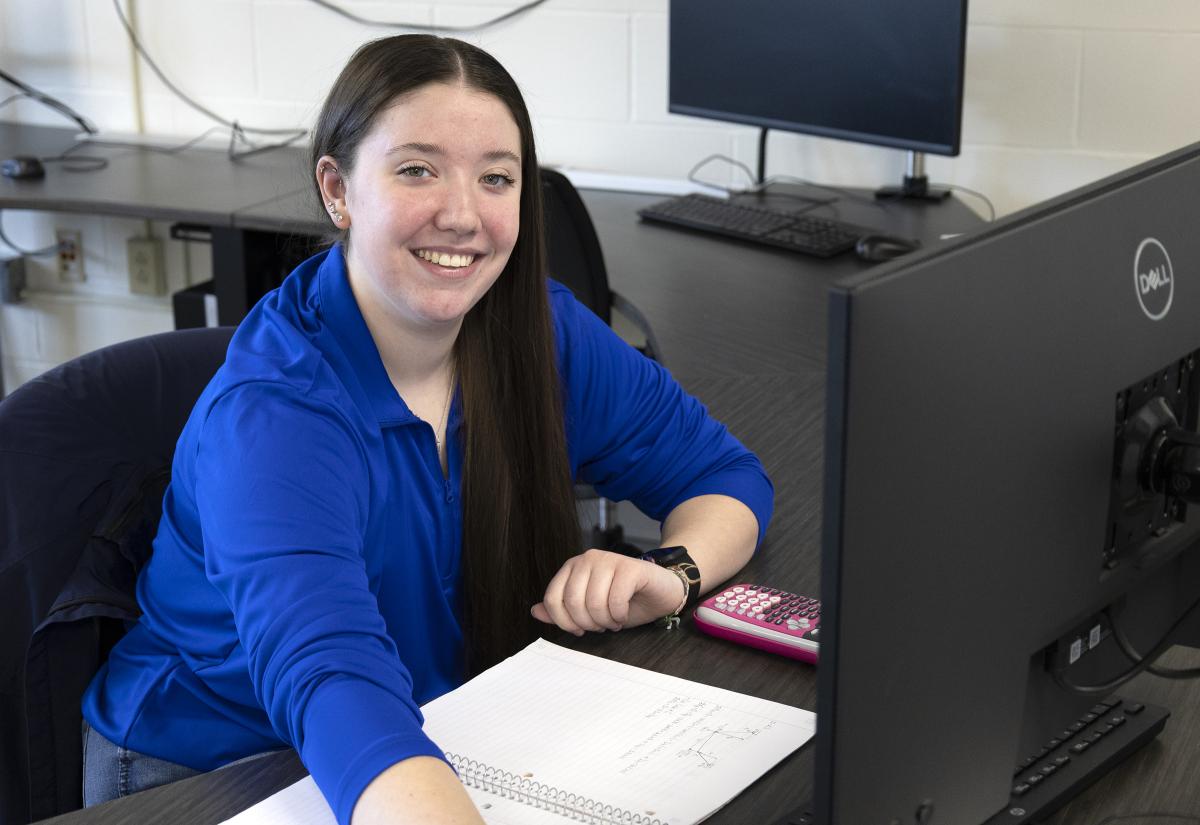 smiling student working on a computer