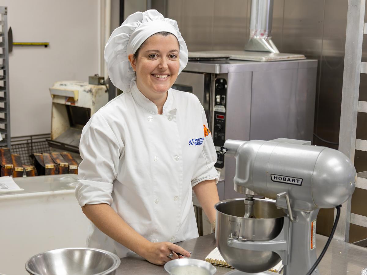 bakery student works on a cake