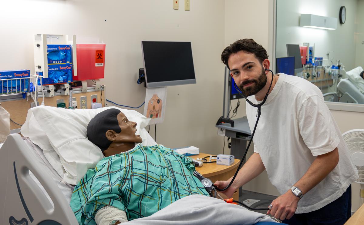 nursing student works in a simulation lab
