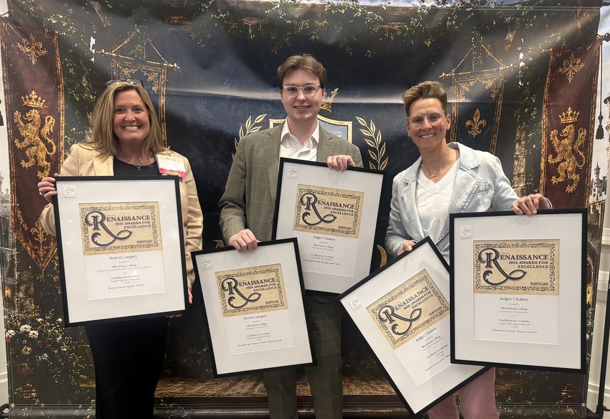 A group of ASC employees displays awards