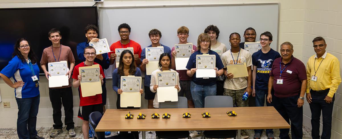 students show off their certificates from robotic camp