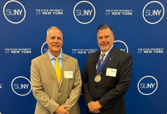 William Dean stands with Dr. Mauro after receiving the SUNY Distinguished Professor Designation