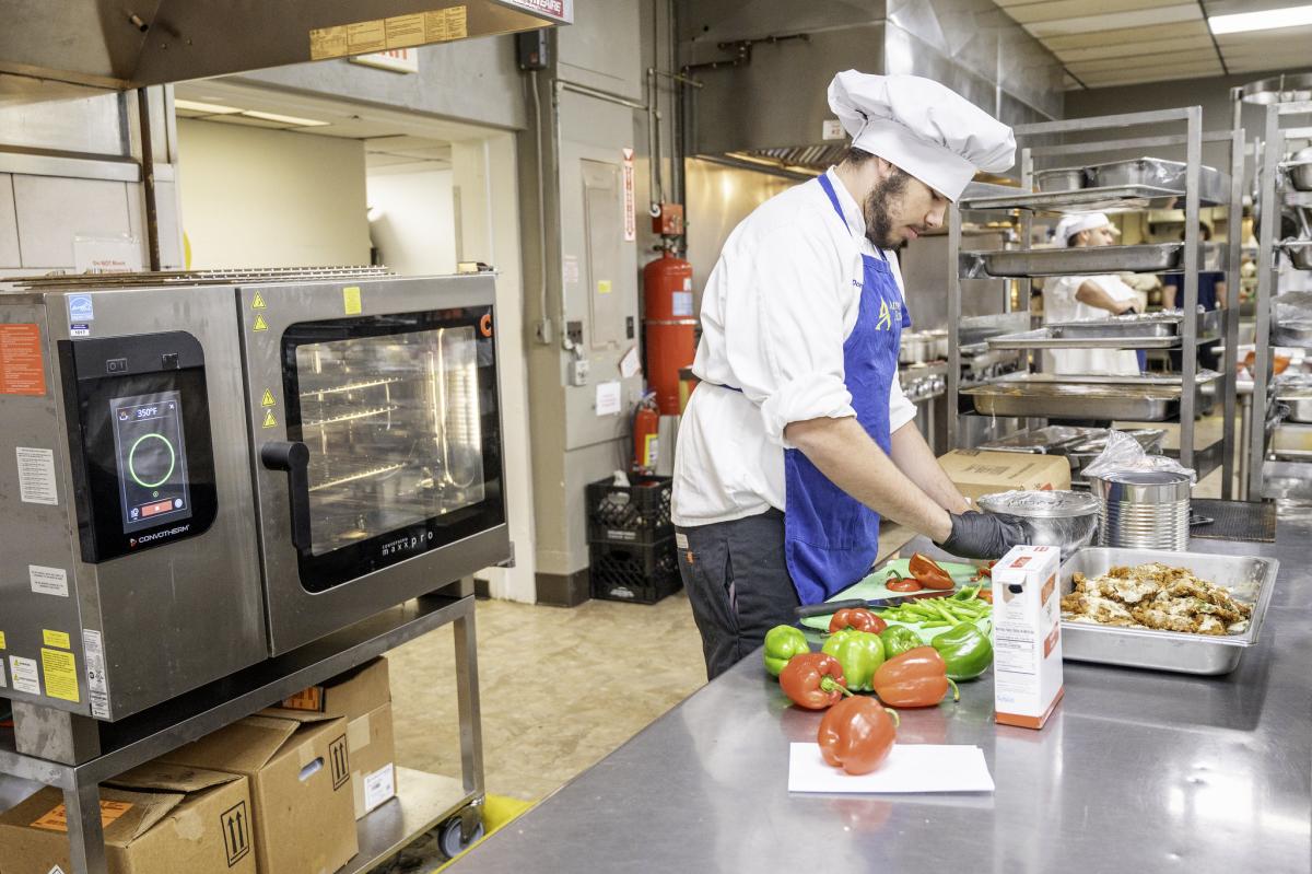 Student cutting in the kitchen