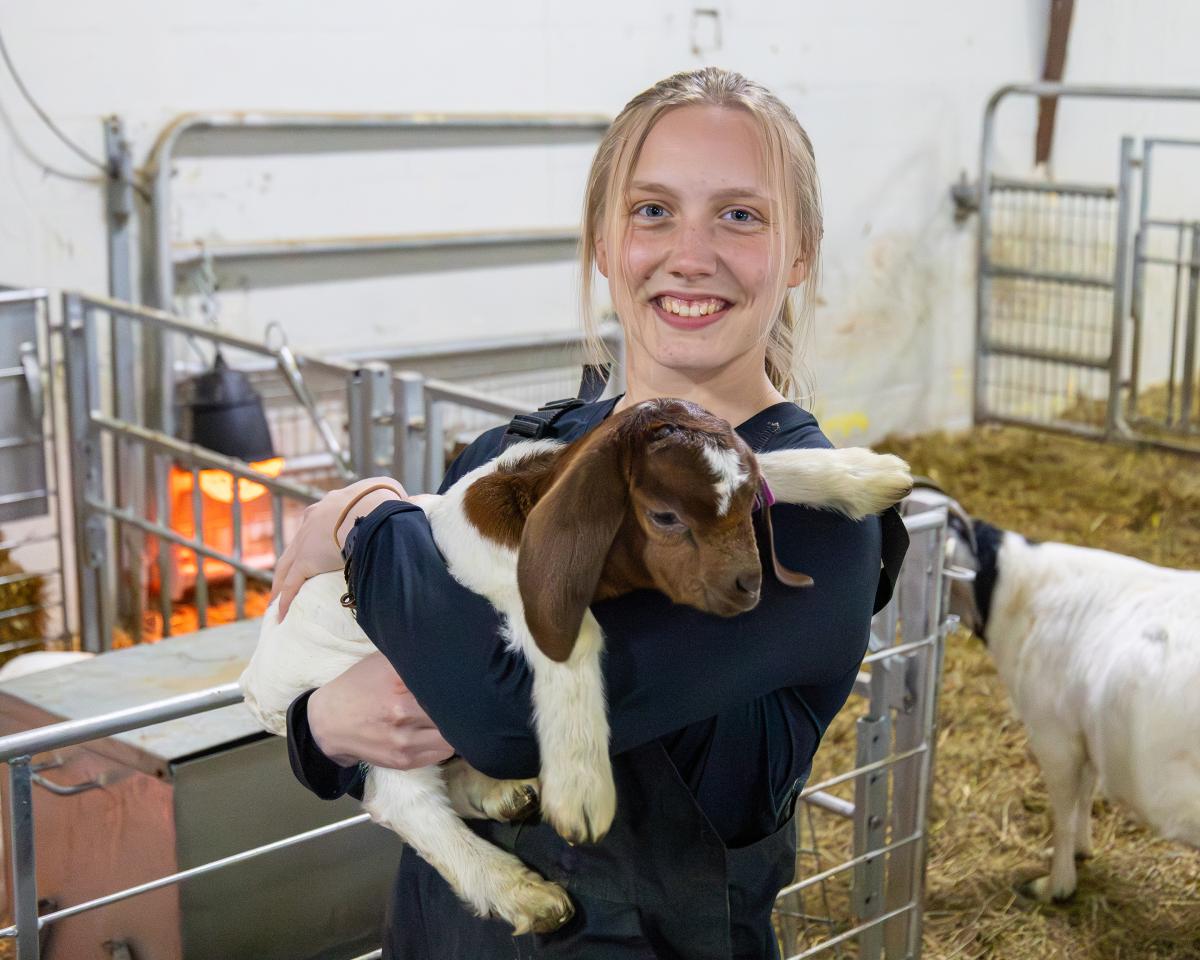student holds an animal