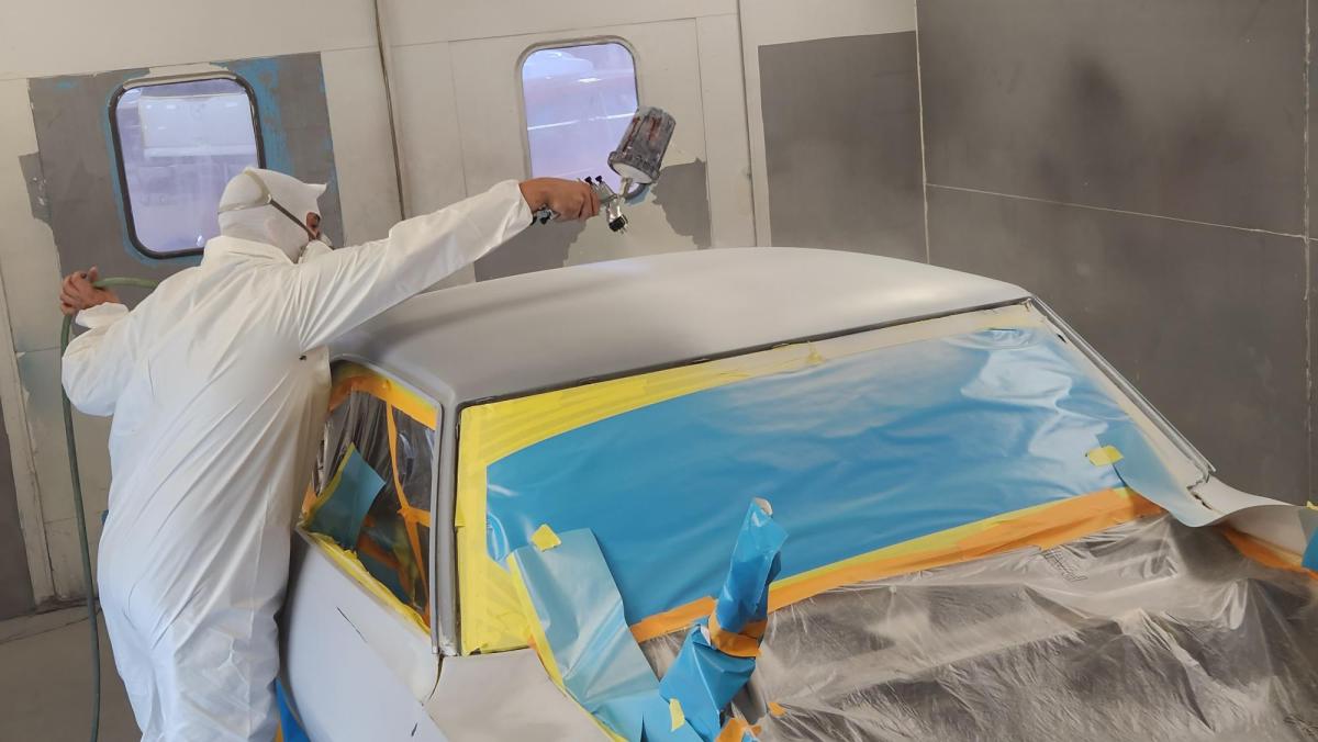 An Alfred State student works on the paint job for the 1969 Pontiac Firebird Trans Am.
