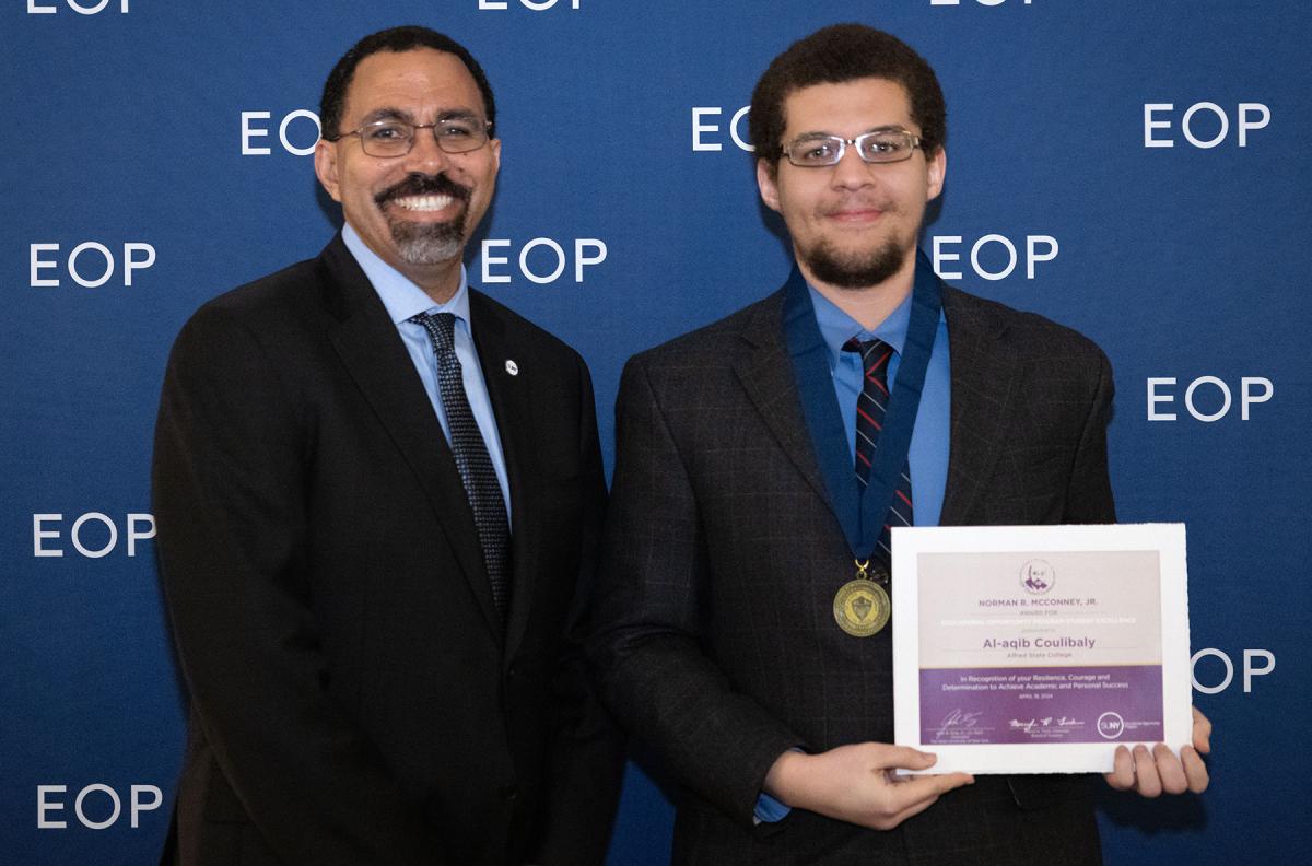 Student accepts award from SUNY Chancellor