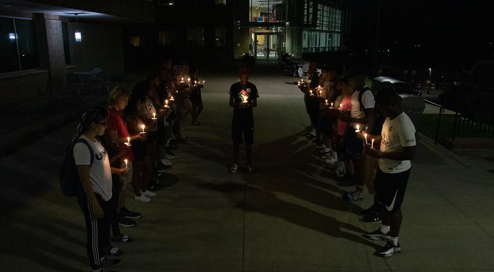Students in UJIMA host a candle light memorial for the victims of 9/11