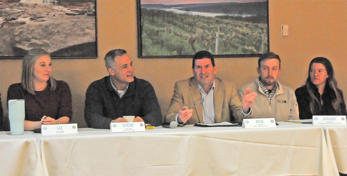 Panel of presenters at a architecture event.