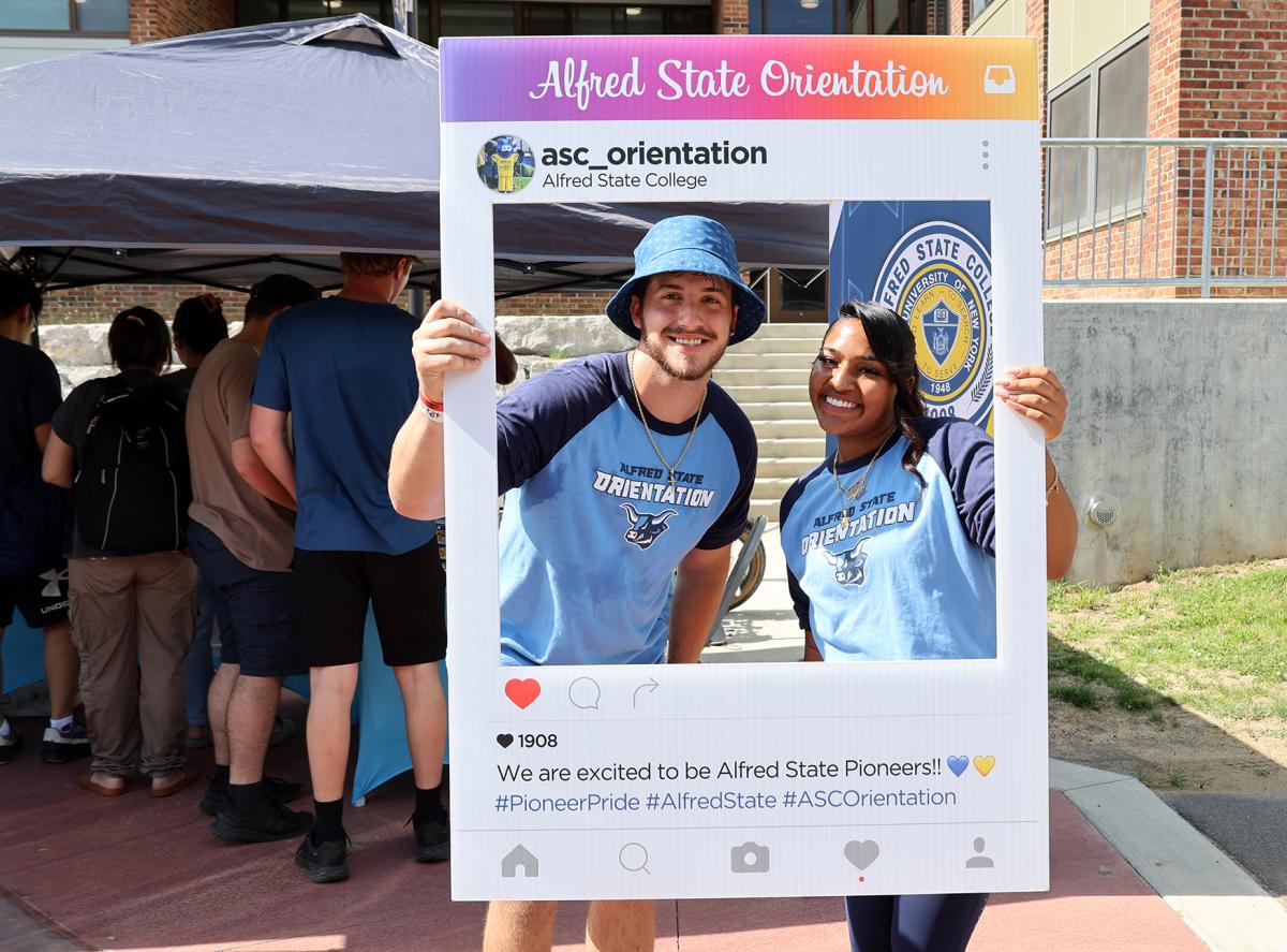 Orientation leaders with an Instagram post sign.
