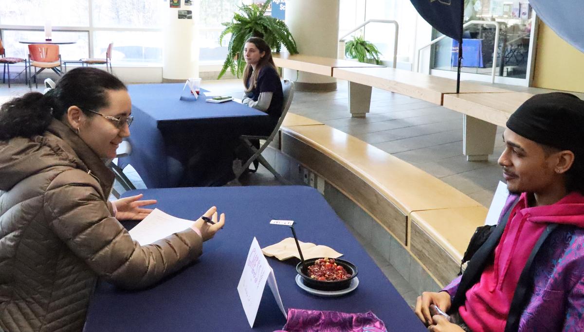 A student ask questions of the actor playing Chessy during a Clue event.